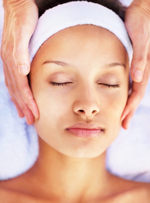 Woman enjoying a facial at the health club spa