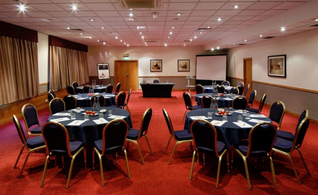 Table and chairs ready for a meeting in the Park View Suite