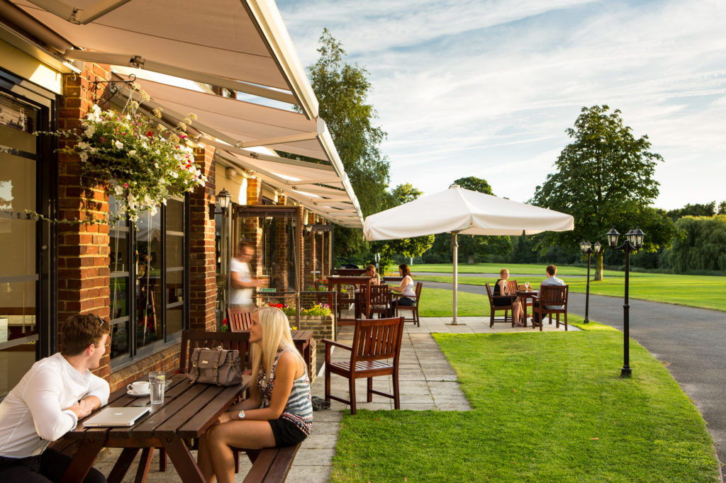 Wide shot of the grounds and sun terrace at Mercure Maidstone Great Danes Hotel