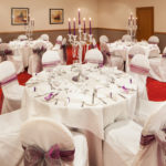 Tables set for a purple wedding breakfast in Park View at Mercure Maidstone Great Danes Hotel
